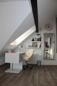 a white room with a desk and a chair at Ferienwohnung Luna in Trier