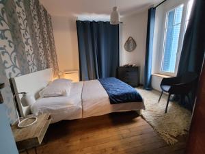 En eller flere senger på et rom på Appartements CDG JOIGNY