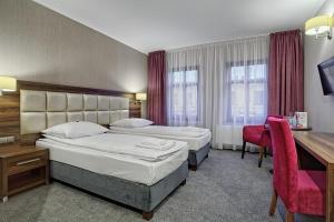 Cama ou camas em um quarto em Hotel Kamieniczka