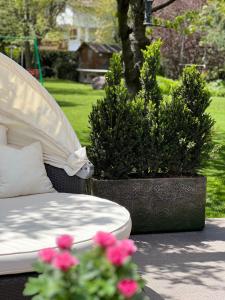 a bed and two potted plants in a yard at Ameiserhof Guesthouse in Collalbo