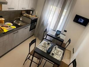 a kitchen with a table with chairs and a laptop on it at B&B Feni in Pompei