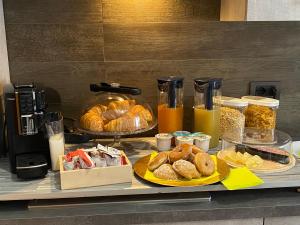 a breakfast table with pastries and other breakfast foods at B&B Feni in Pompei