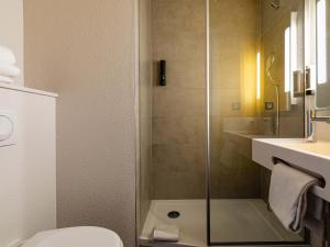 a bathroom with a shower and a toilet and a sink at B&B HOTEL Sélestat Centre-Alsace in Sélestat