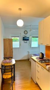 a kitchen with a table and a chair in a room at Apartments Neven in Omiš