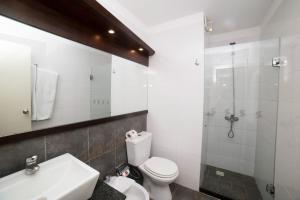 e bagno con servizi igienici, lavandino e doccia. di 27 Suites Hotel a Montevideo