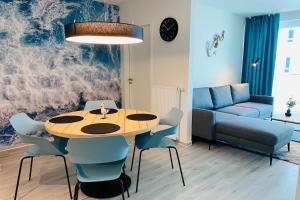 a dining room with a table and chairs and a couch at Fewo 3-13 Ostsee in Kappeln