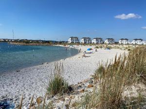 a beach with people laying on the sand and the water at Fewo 3-13 Ostsee in Kappeln