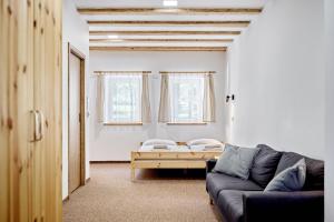 a living room with a couch and a table at Pension Barborka in Boží Dar