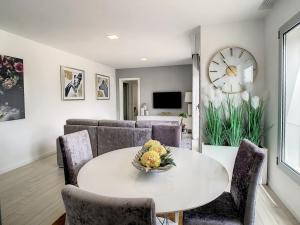 a dining room with a white table and chairs at Rancho Tá-Mar Apartment Nazaré Beach in Nazaré