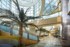 a palm tree in the lobby of a building at Sheraton Myrtle Beach in Myrtle Beach