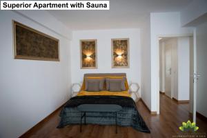 um quarto com uma cama e duas fotografias na parede em Sibiu Lotus Apartments em Sibiu