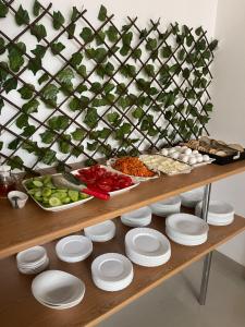 a buffet with plates and bowls of food on a table at Green Yard Hotel in Batumi