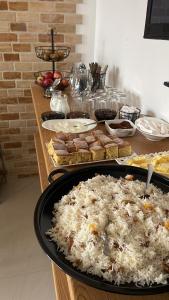 a table with rice and other food on it at Green Yard Hotel in Batumi