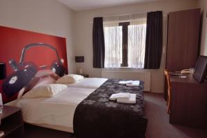 a hotel room with a bed with towels on it at Royal in Deventer