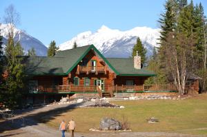 two men standing in front of a log cabin at Moberly Lodge in Golden