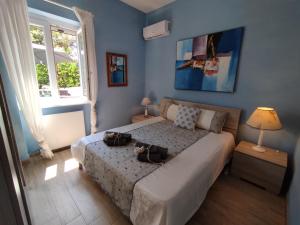 a bedroom with a bed with two bags on it at GAETA - Villa Fontania in Gaeta