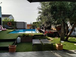 a backyard with a swimming pool and two chairs at GAETA - Villa Fontania in Gaeta