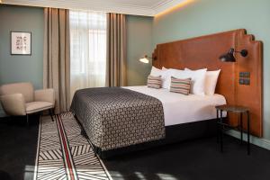 A bed or beds in a room at Maison Rouge Strasbourg Hotel & Spa, Autograph Collection