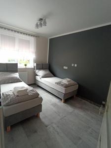 Postelja oz. postelje v sobi nastanitve Apartament Brzeg