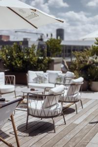 a group of chairs and tables on a roof at Gekko House Frankfurt, a Tribute Portfolio Hotel in Frankfurt/Main