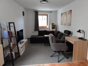 a living room with a couch and a table at Haus Blumenampel in Schmalkalden