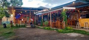 a building with a restaurant with lights on it at Achita Cottages in Senaru