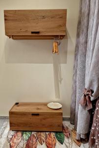 a wooden bench on the floor next to a curtain at Alkionisnest in Arkoudi