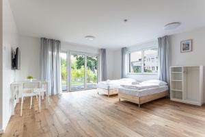 A bed or beds in a room at T&K Apartments - Bergisch Gladbach - 3 Comfortable Apartments - 18 min to Fair Messe Cologne