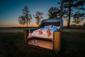 a couple of women laying on a bed in a field at Marina Martinshafen - Beach life in Sassnitz