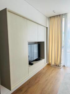 a living room with a flat screen tv in a wall at Madalin Seaside Apartment in Vlorë