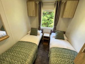 Cama ou camas em um quarto em 3 Bedroom Caravan LG34, Lower Hyde, Shanklin