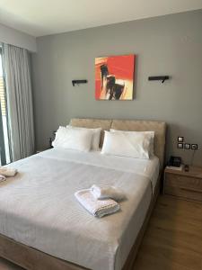 um quarto com uma cama grande e uma toalha em The Victoria Lefkada em Lefkada Town