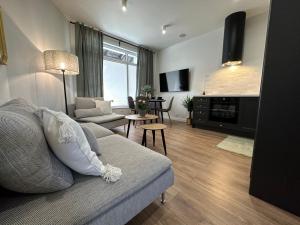 a living room with a couch and a table at Abrahama Green House in Władysławowo