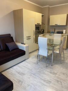 een keuken en een woonkamer met een tafel en stoelen bij Iva Luxury Apartament in Ruse