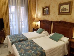 Cama ou camas em um quarto em Hotel Europa Boutique Sevilla