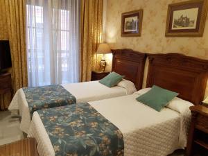 Cama ou camas em um quarto em Hotel Europa Boutique Sevilla