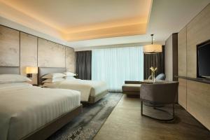 Ένα ή περισσότερα κρεβάτια σε δωμάτιο στο Yogyakarta Marriott Hotel