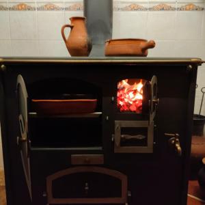 a pizza oven with a fire in it at Casa da Muralha in Estremoz