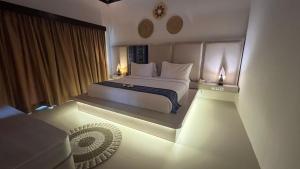 a bedroom with a bed with two lights on it at Living Asia Resort and Spa in Senggigi 