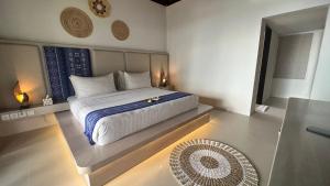 a bedroom with a king sized bed with aokedokedokedoked at Living Asia Resort and Spa in Senggigi 