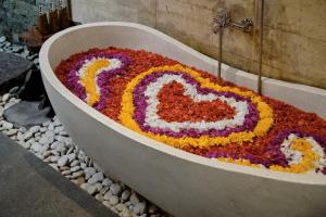 una bañera con arreglo floral en el medio en Teja Lokha Ubud Villa, en Ubud