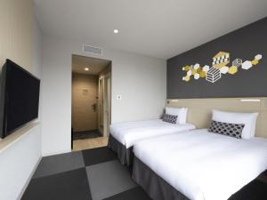 Säng eller sängar i ett rum på ibis Styles Tokyo Ginza East