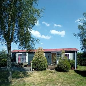 a house with a tree in front of it at Slapen op De Bult Green 2 persons in De Bult