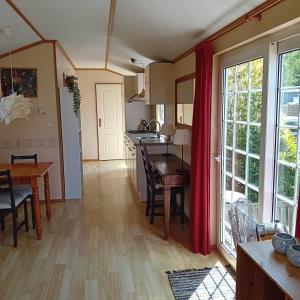 a kitchen and dining room with a table and a dining room at Slapen op De Bult Green 2 persons in De Bult