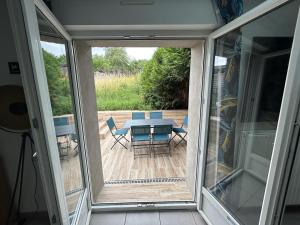 a screened in porch with a table and chairs at Résidence 3 etoiles Les thèmes Proche Lux, Metz, Cattenom in Hayange