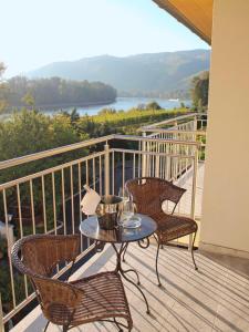 d'une terrasse avec une table et des chaises sur un balcon. dans l'établissement Gartenhotel & Weingut Pfeffel Dürnstein, à Dürnstein