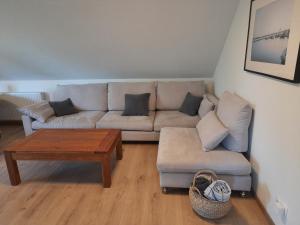 a living room with a couch and a coffee table at Ferienwohnung Rosi in Schleswig