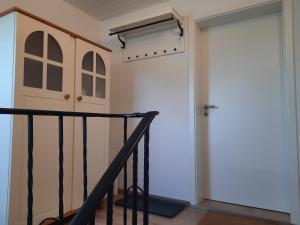 a hallway with a door and a stairway at Ferienwohnung Rosi in Schleswig