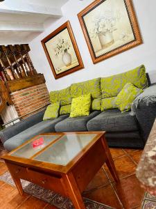 a living room with a couch and a coffee table at Apartamentos Nel I in Santillana del Mar