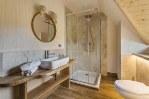 a bathroom with a sink and a shower at Willa Skała in Kościelisko